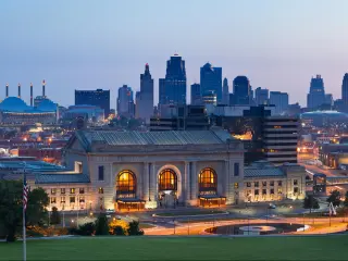 Panoramic view of the Kansas City skyline with visible skyscrapers of the downtown district at sunrise.
