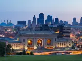 Panoramic view of the Kansas City skyline with visible skyscrapers of the downtown district at sunrise.