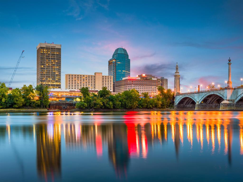 Springfield, Massachusetts, USA downtown skyline on the river at dusk.