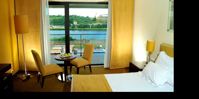 A bedroom with a view in Vila Galé Coimbra hotel in Portugal