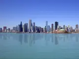 Chicago, USA with the city skyline against a blue sky with water in the forehand. 