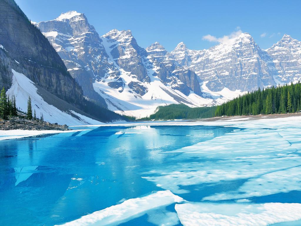 Banff National Park, Canada taken at Moraine Lake under the ice at morning spring time with mountains in the distance.