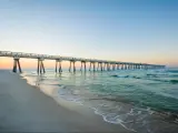 M.B. Miller County Pier and Gulf of Mexico at sunrise, in Panama City Beach, Florida, with white sands below