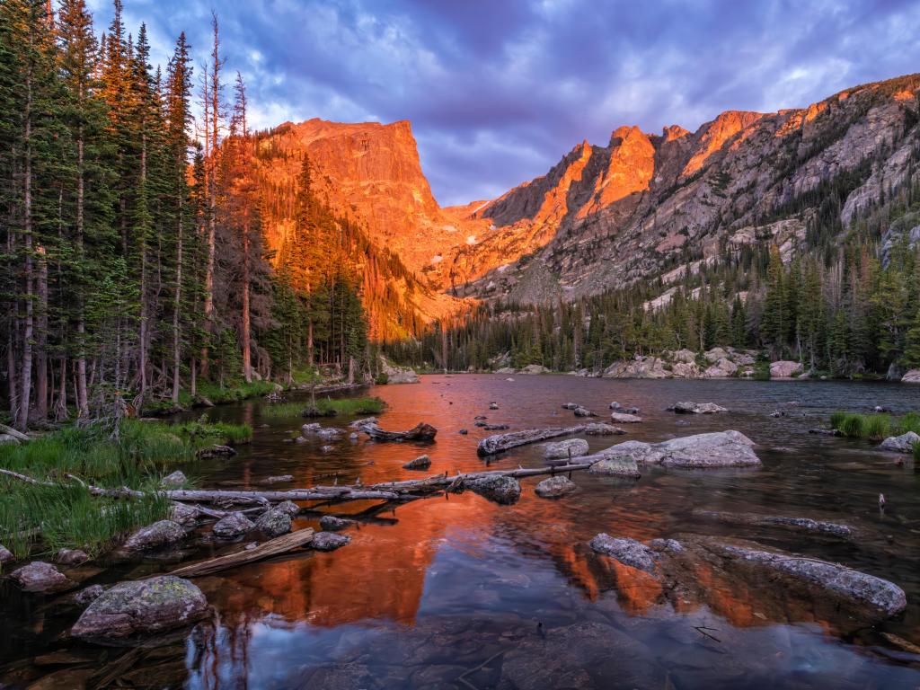 Warm morning light glistens on Dream Lake near Hallett Peak and Flattop Mountain in Rocky Mountain National Park, Estes Park, Colorado