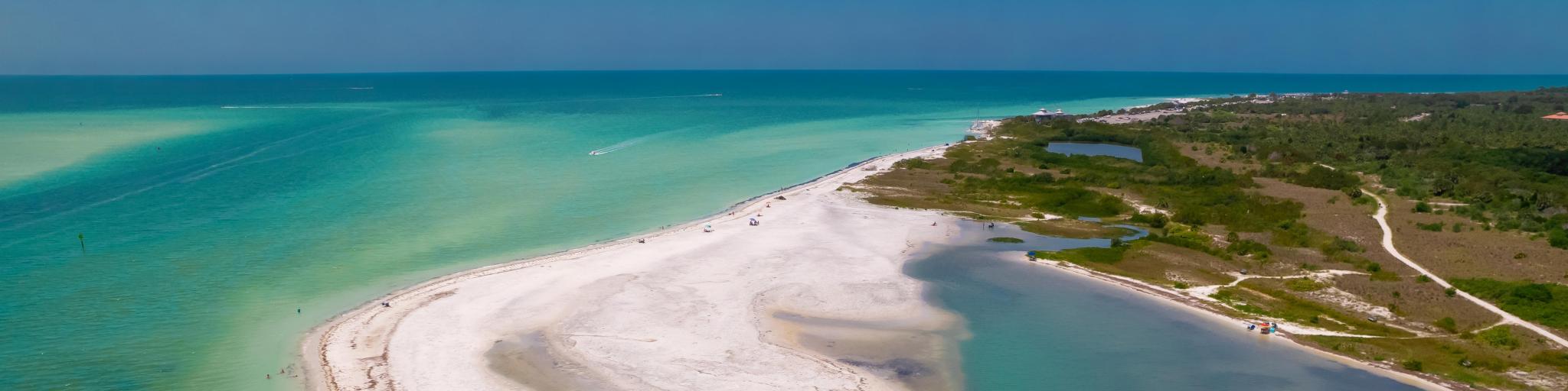 Florida beach. Paradise Summer vacation. Panorama of Caladesi island and Honeymoon Island State Park. Blue-turquoise color of salt water. Ocean or Gulf of Mexico. Tropical Nature. America. Aerial view