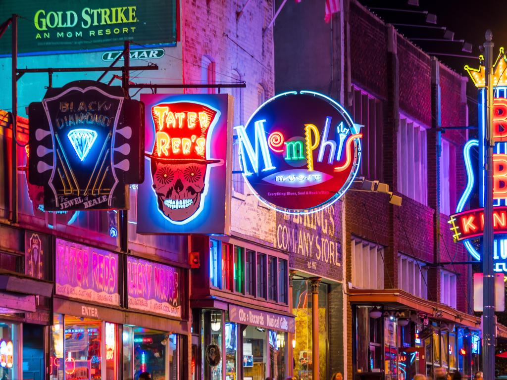 Memphis, USA with neon signs of famous blues clubs on Beale Street at night. 