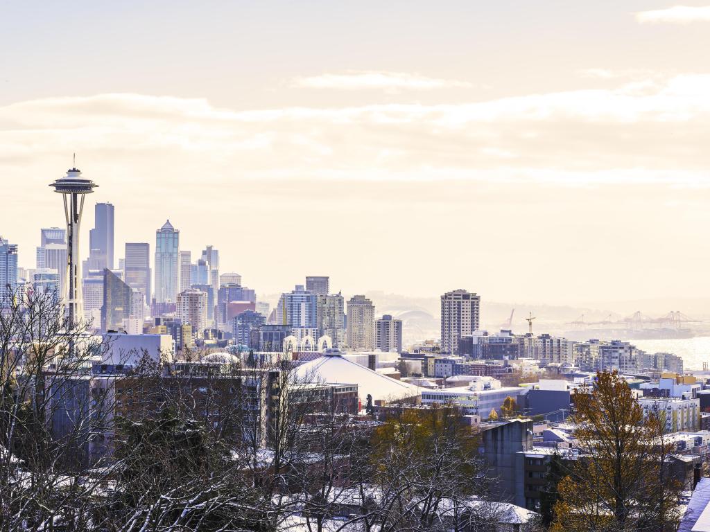 Seattle, Washington skyline with mountains behind in the winter with snow all around