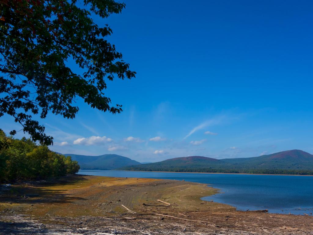  A beautiful early fall day with bright blue sky along the shoreline of the Ashokan Reservoir in upstate New York, with with the Catskill Mountains in the background.