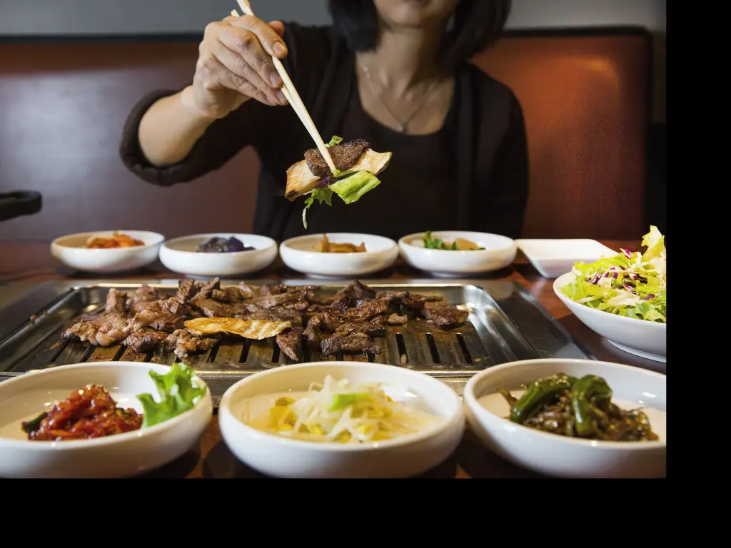 Korean style BBQ with thinly sliced beef and side dishes