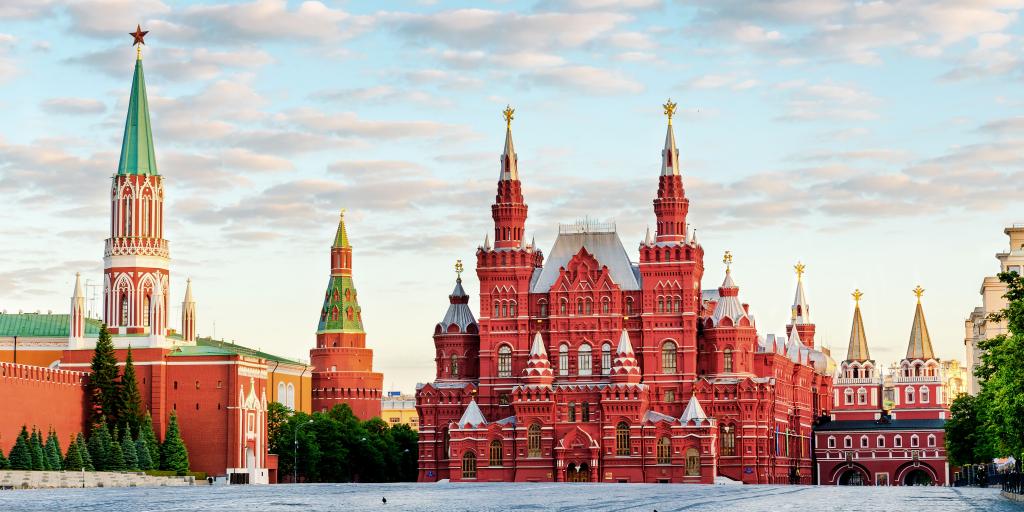 The red ornate exterior of the State Historical Museum, Moscow, with the cobbles of the Red Square in front