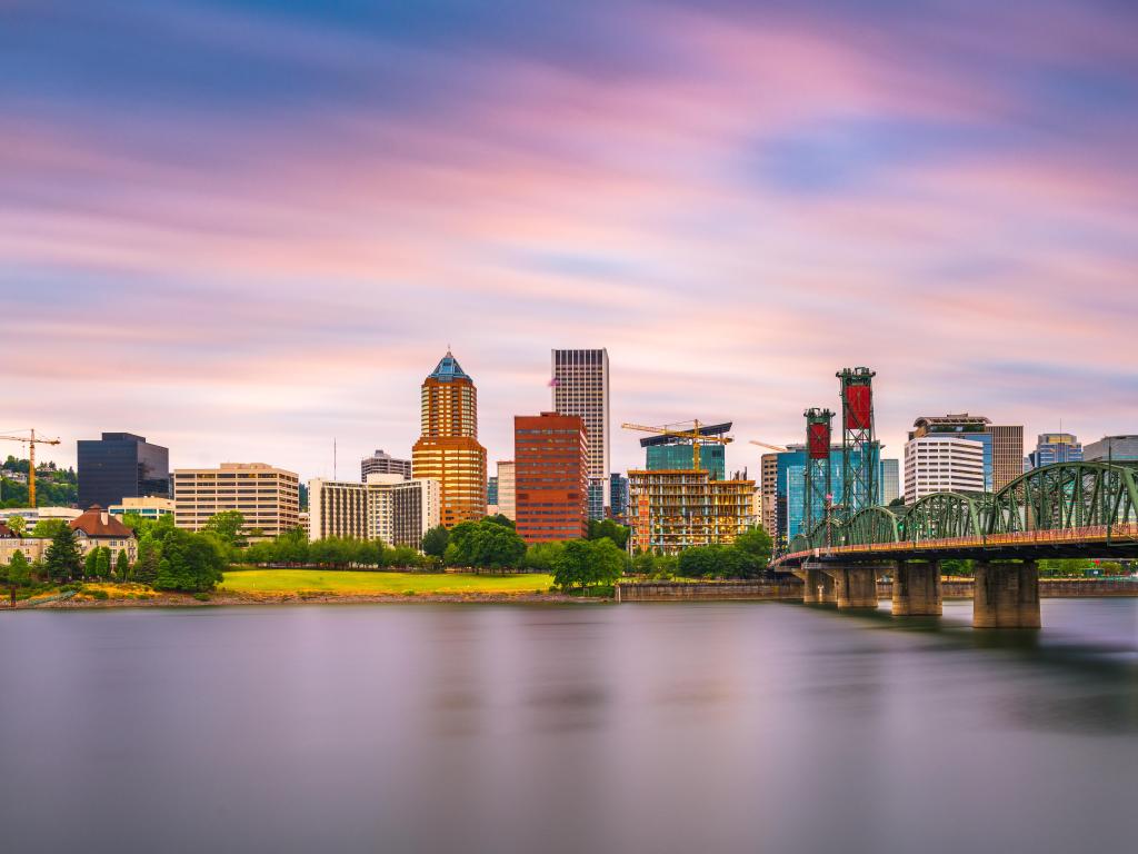 Portland, Oregon, USA with the city skyline in the background and taken at dusk and the Willamette River in the foreground.
