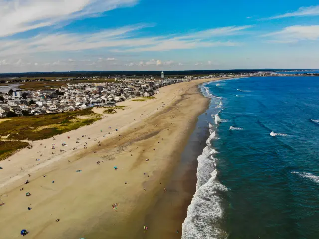 Aerial view of Hampton Beach, with sandy coastline dotted with sunbathers