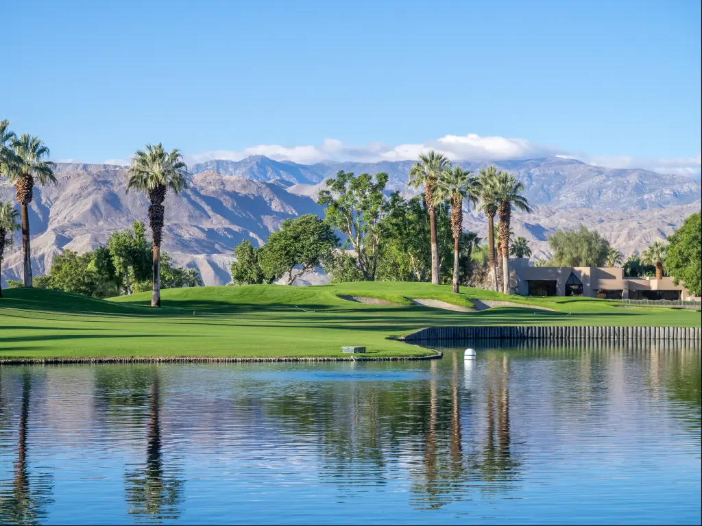 Palm trees, perfectly manicured lawns and water features of a golf resort in Palm Springs, California