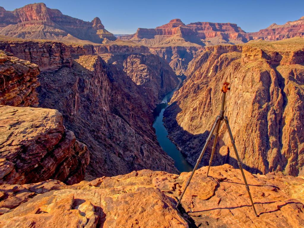 View of the Grand Canyon from the western side of Plateau Point. There is a camera tripod at the edge of the cliff.