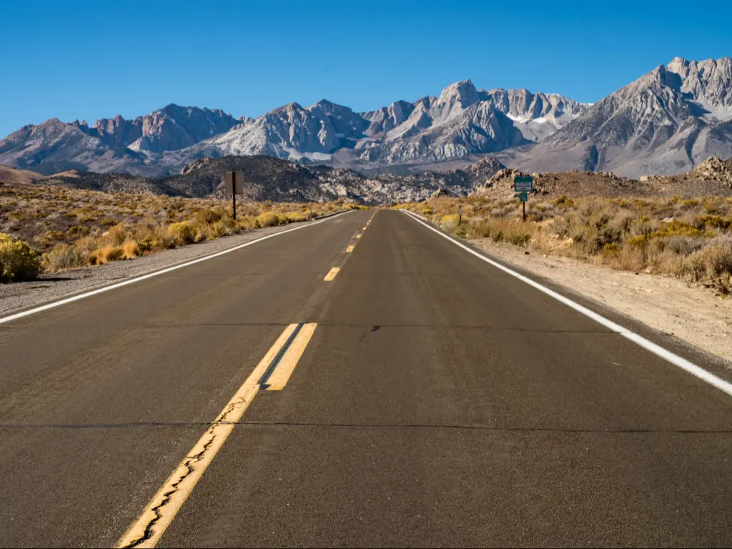 A bright sunny day on an empty road to Inyo National Forest with a great view of the Eastern Sierra Nevada Mountains.