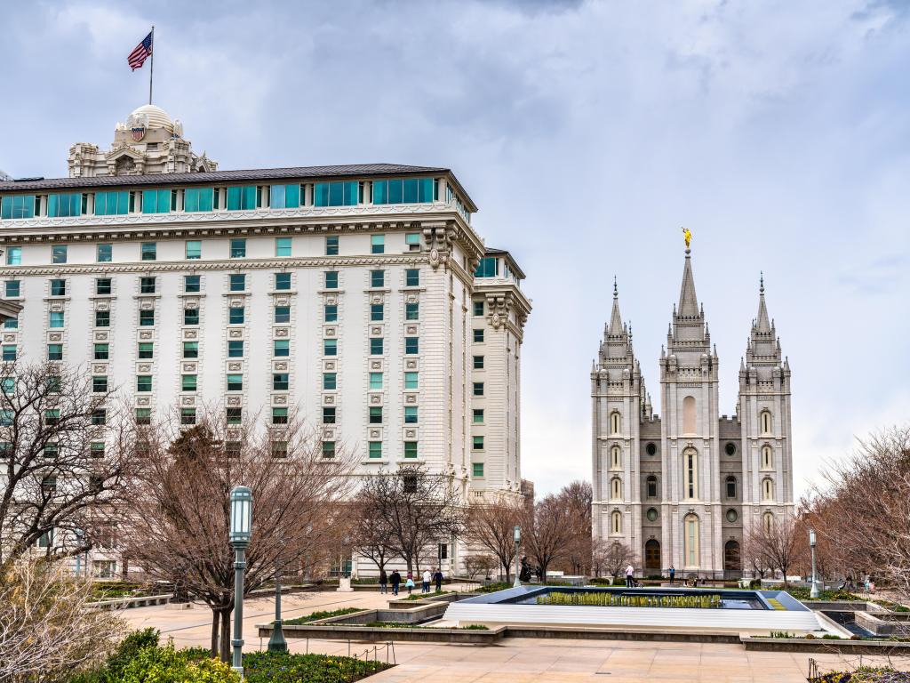 The historic, white building with the famous Salt Lake City Temple in the background