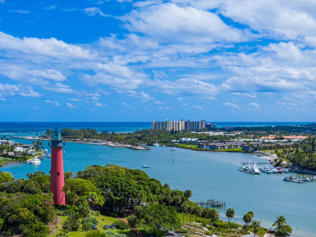 Jupiter Island Lighthouse,Palm Beach County, Florida with an aerial shot above the red Jupiter Island Lighthouse surrounded by the sea and tree covered islands. 