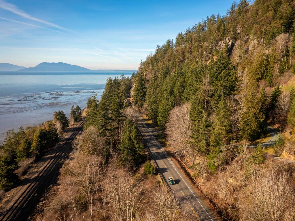Aerial View of the Historic Chuckanut Drive with trees to one side and water to the other