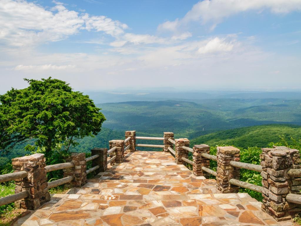 Sandy coloured walkway looking out over extensive rolling green hills