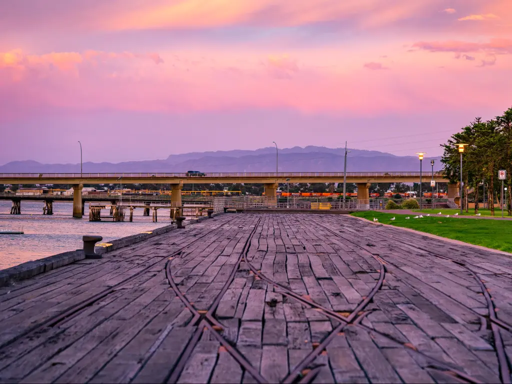 Sunset in Port Augusta, Australia with a path in the foreground, bridge and hills in the distance. 