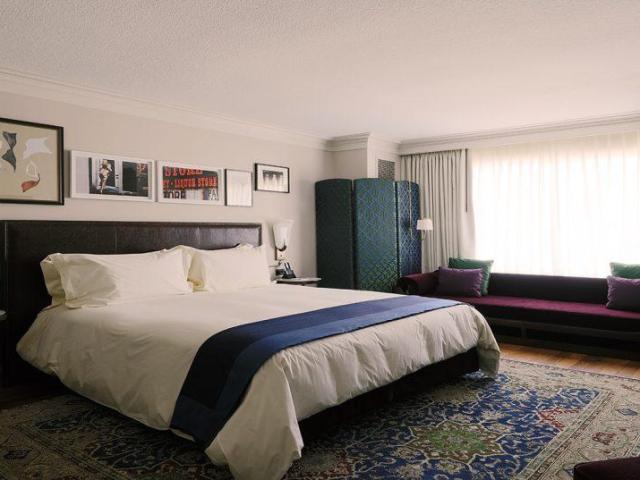 Plush European inspired bedroom interior at NoMad Hotel, Las Vegas