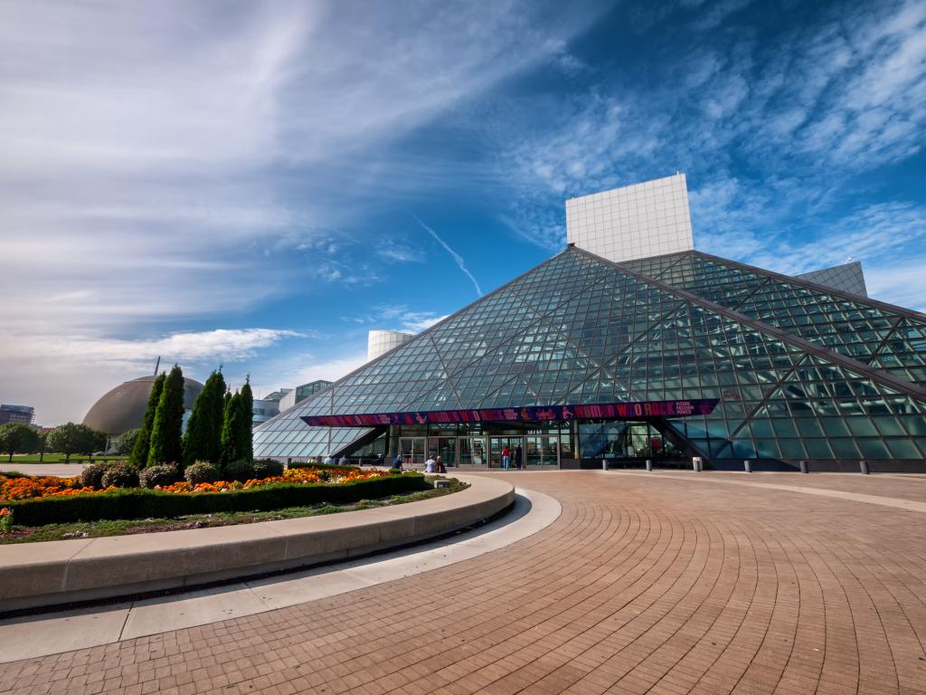 The Rock & Roll Hall of Fame in Cleveland with its pyramid structure during a bright day.