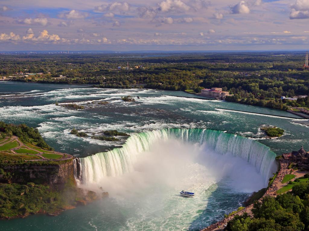 Aerial view of Horseshoe Falls including Maid of the Mist sailing on Niagara River, Canada and USA natural border