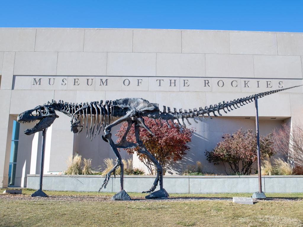 Exterior of the Museum of the Rockies with an intact T-Rex skeleton in the foreground