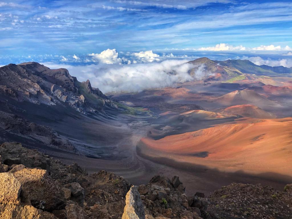 Sliding sand swirls across the valley in Haleakalā National Park, Hawaii, as seen from the mountains