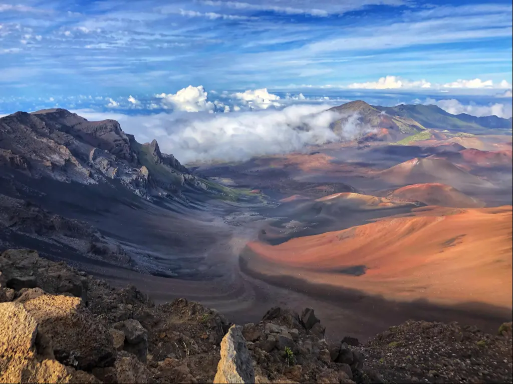 Sliding sand swirls across the valley in Haleakalā National Park, Hawaii, as seen from the mountains