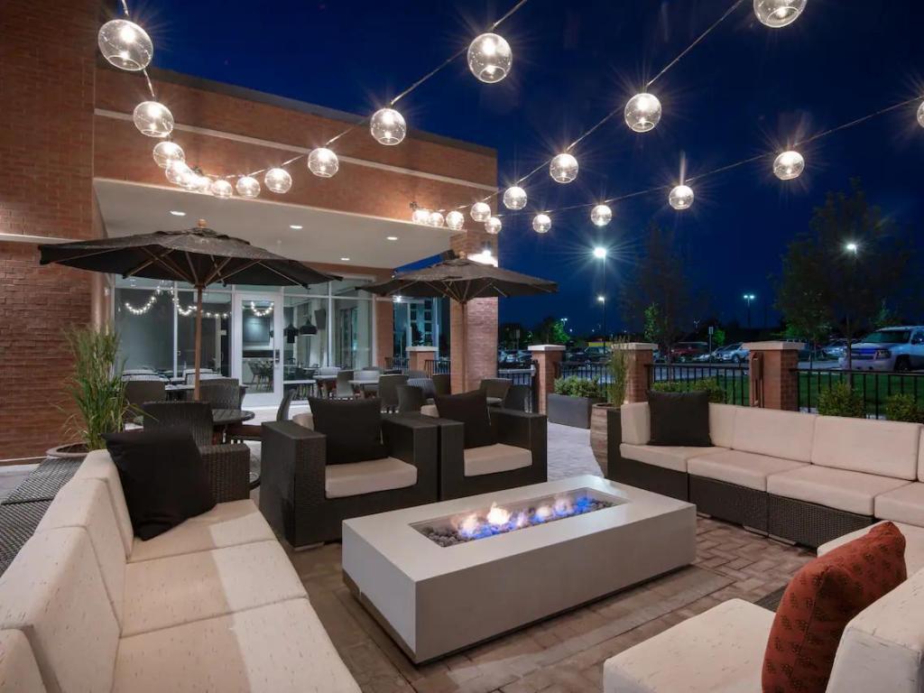 Outdoor terrace with firepit and loungers during early evening at Hyatt Place Denver Westminster
