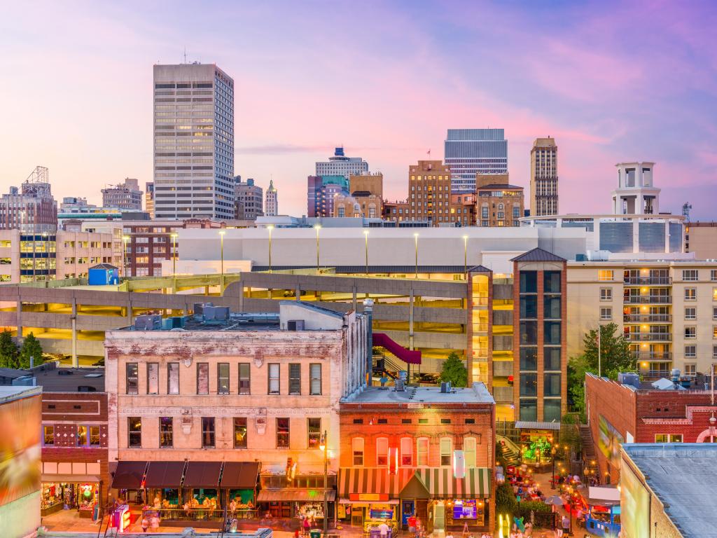 Memphis, Tennessee, USA with the city skyline over Beale Street at dusk.