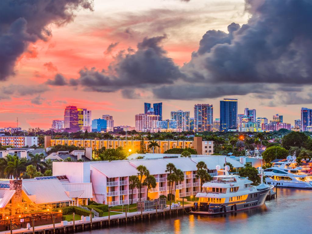 Fort Lauderdale, Florida, USA skyline taken at sunset with the sea and boats in the foreground and the city skyline in the distance. 