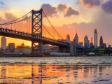Philadelphia, PA, USA with the panorama of Philadelphia skyline, Ben Franklin Bridge and Penn's Landing at sunset.