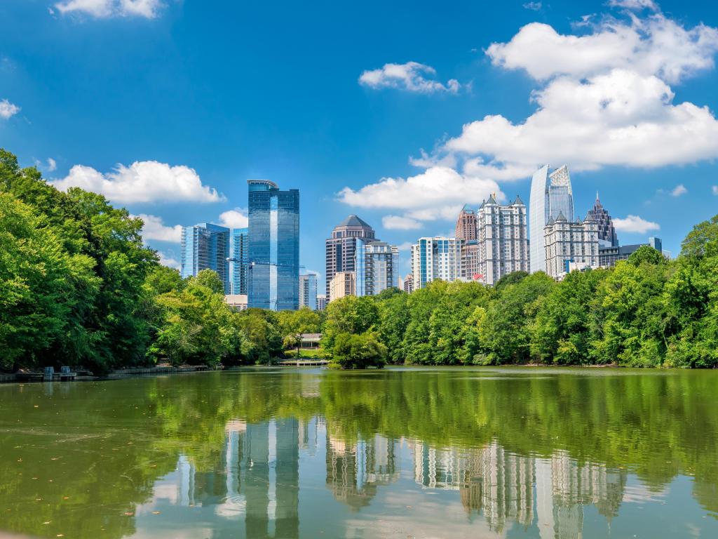 Atlanta, Georgia, USA with a view of midtown Atlanta skyline from the park and the buildings reflecting in the waters edge.
