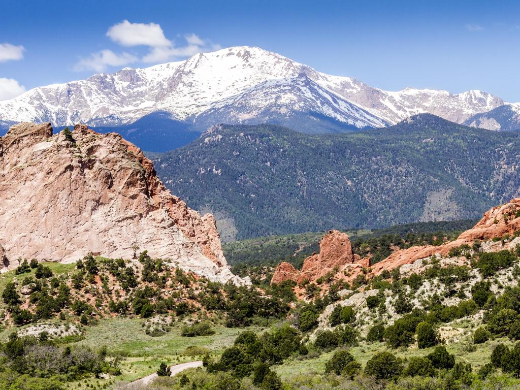 Pikes Peak as seen from Garden of the Gods Park in Colorado Springs Colorado on a sunny day with some clouds. 