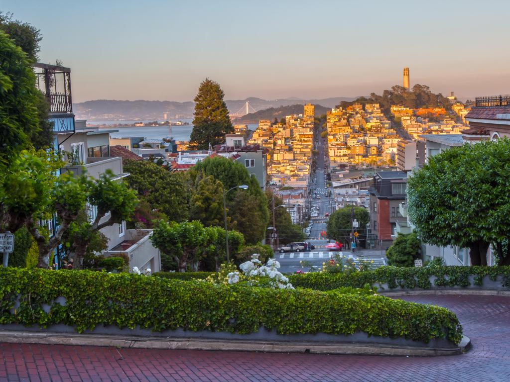 Lombard Street, San Francisco, USA with a view of the city in the distance.