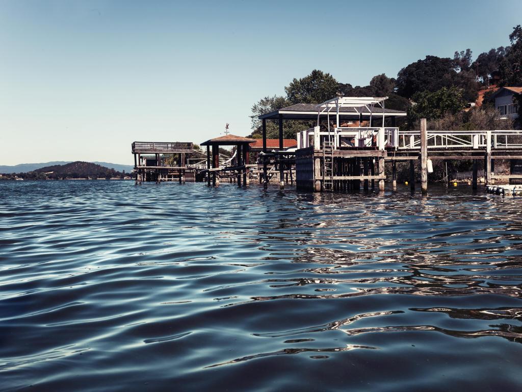 Fishing hut on the Clear Lake. Summer day background. Landscape with river.