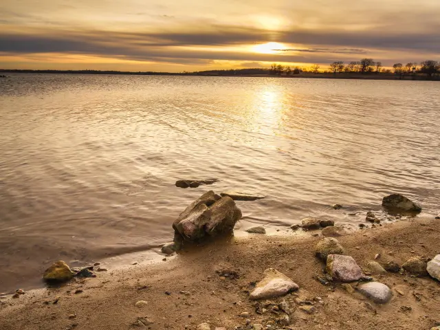 Reflection of the sunset over the tranquil waters of the lake near Kansas City