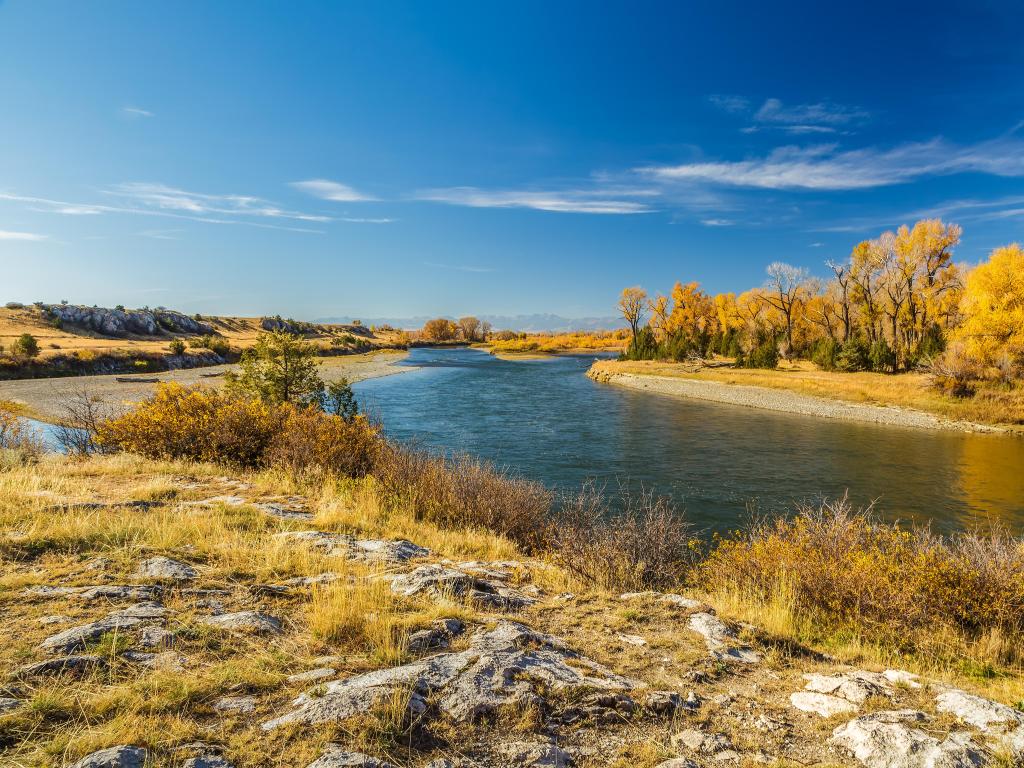 Three Forks, Montana, USA with the Missouri River flowing through the Missouri Headwaters State Park, grass and trees surrounding the river and taken on a clear sunny day.