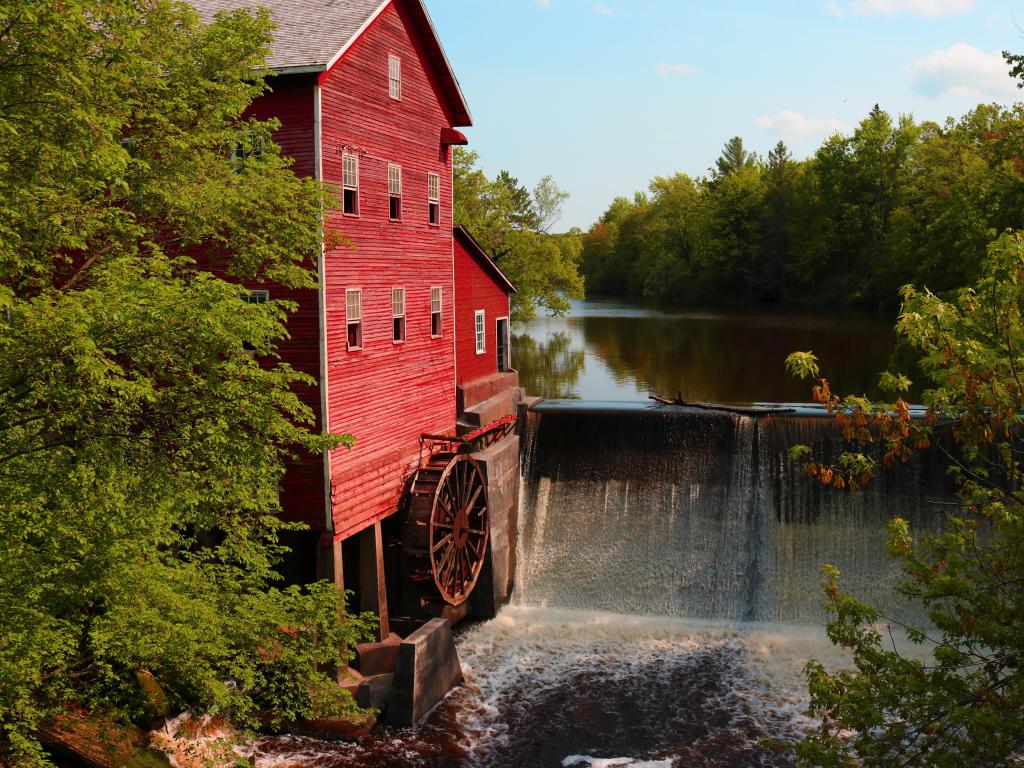 Dells Mill, Wisconsin, USA currently ran by the Amish in Wisconsin with the red mill beside a waterfall taken on a clear sunny day.