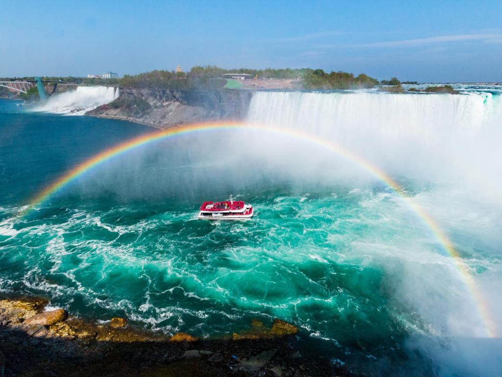 Niagara Falls Hornblower Cruise Boat Approaching Waterfall Under a Perfectly Arched Rainbow