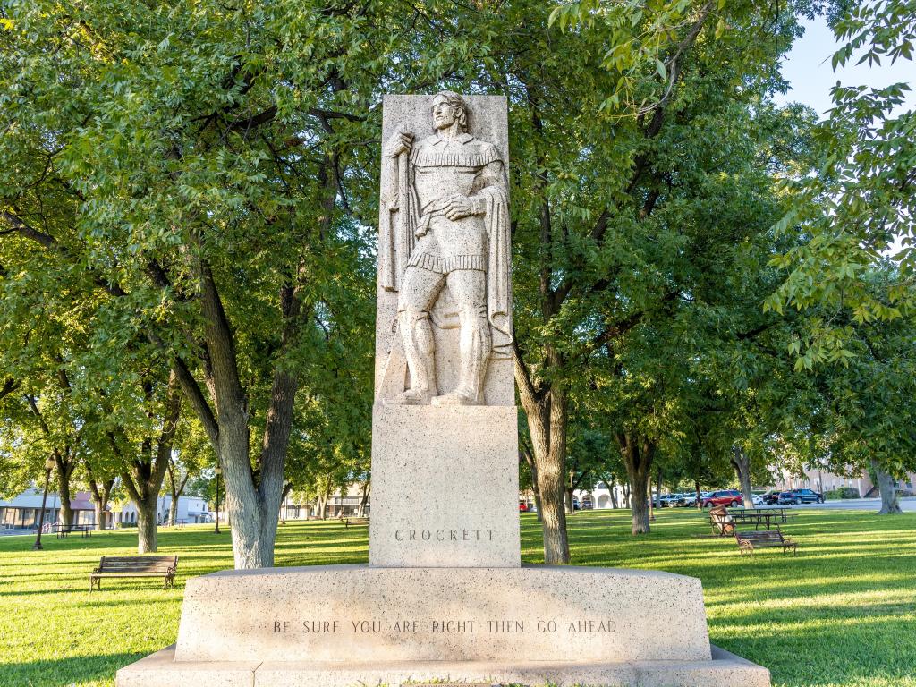 The Art Deco style sculpture of David Crockett (the Alamo's hero), situated in a city park.