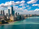 Chicago, Illinois, USA with the skyline aerial drone view from above, city of Chicago downtown skyscrapers and Lake Michigan in the foreground taken on a sunny but cloudy day.