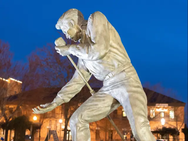 White stone statue of Elvis Presley singing