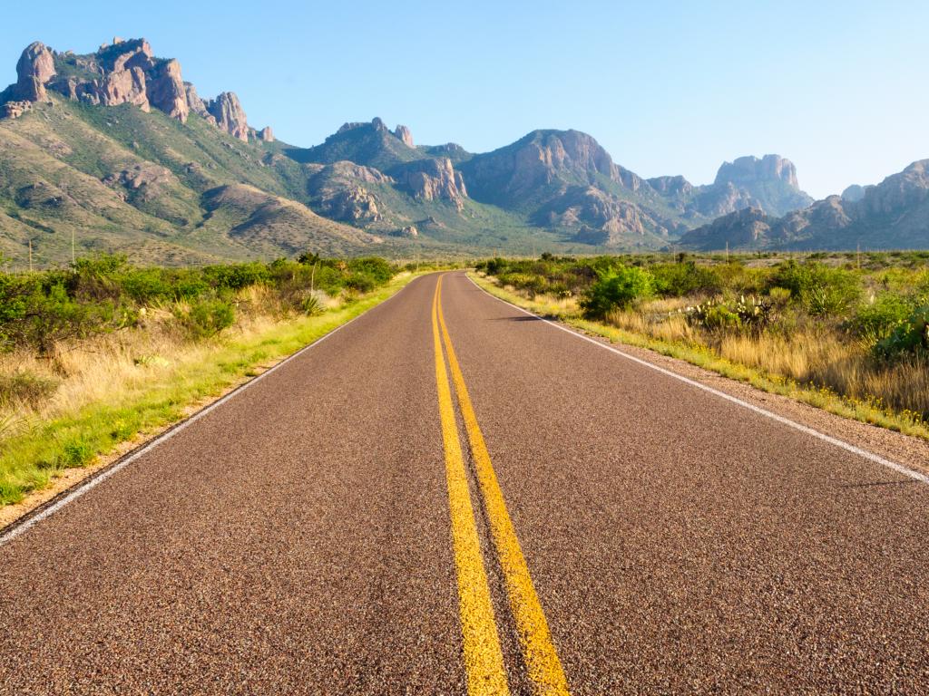 Road running through the Big Bend National Park in Texas with mountains in the background.