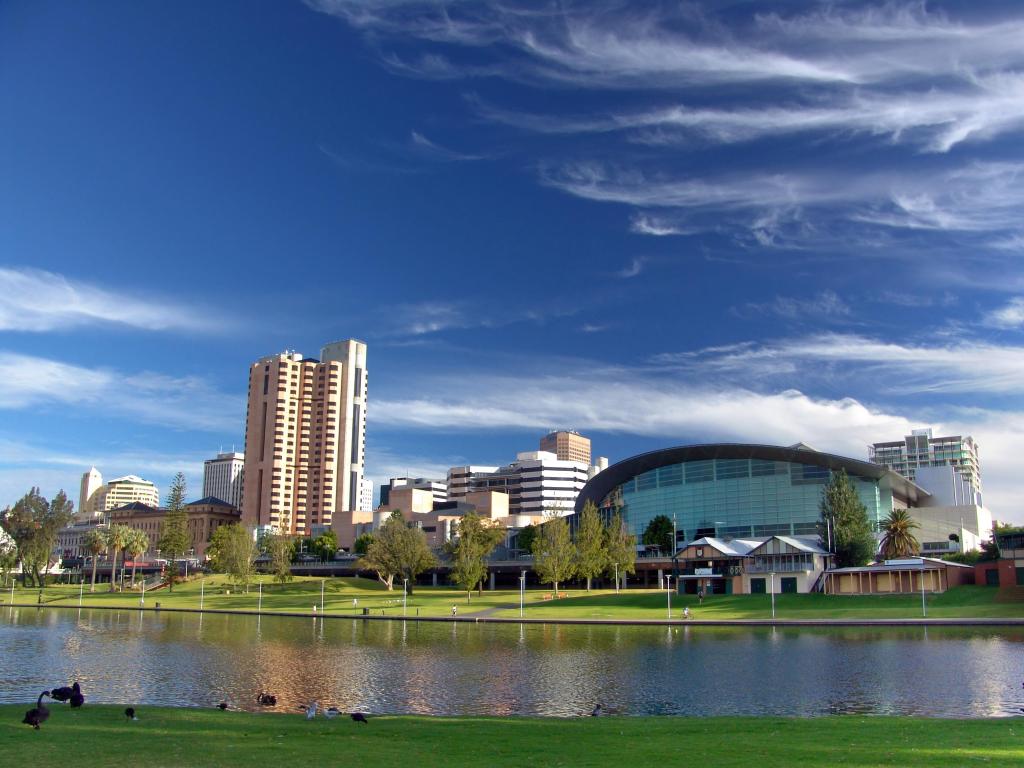 Adelaide, Australia with a view of the city in the distance and the River Torrens in the foreground on a sunny day.