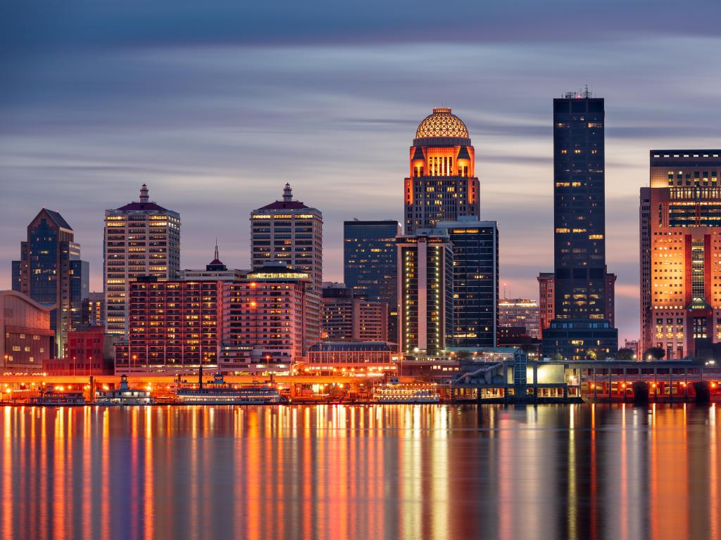 Louisville, Kentucky, USA skyline on the Ohio River at night.