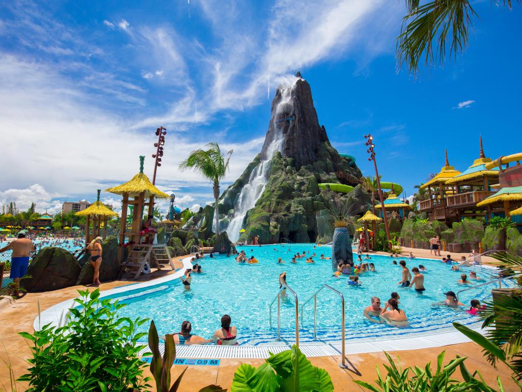 Universal Orlando Resort, Orlando at a water park with a volcano and pool in the foreground on a sunny day.