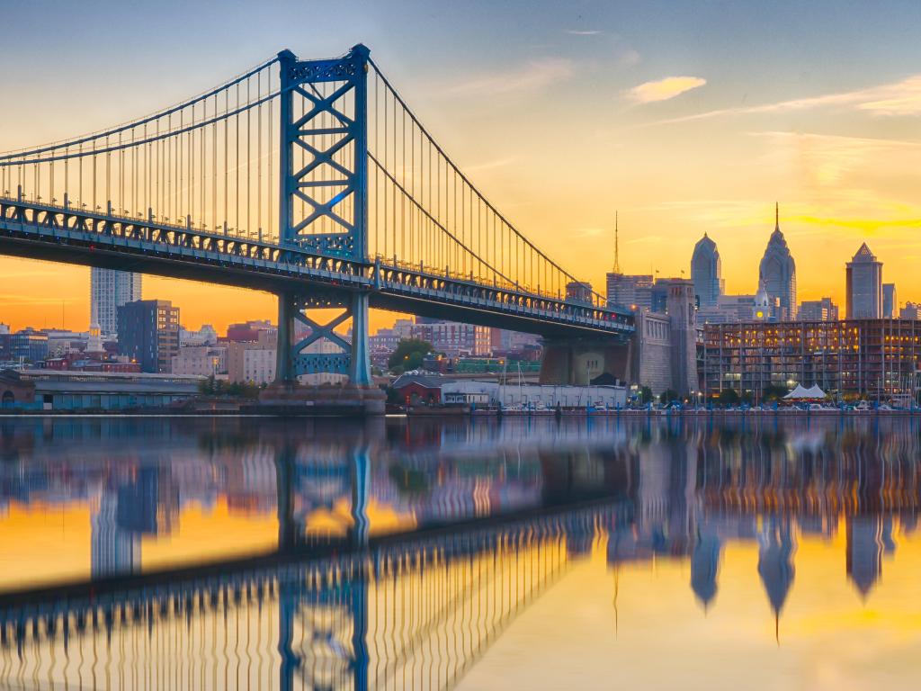 Philadelphia sunset skyline and Ben Franklin Bridge refection from across the Delaware River